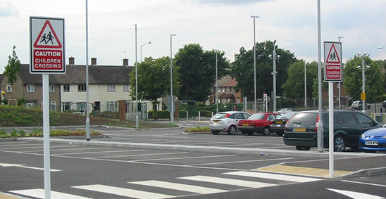 Car park signs and road markings in school car park.