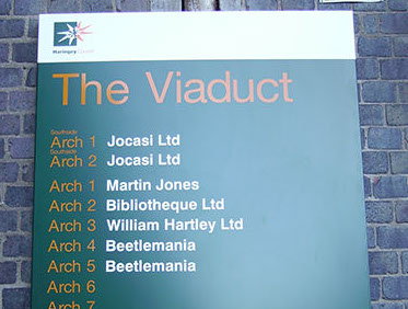 Wall mounted aluminium industrial estate sign.