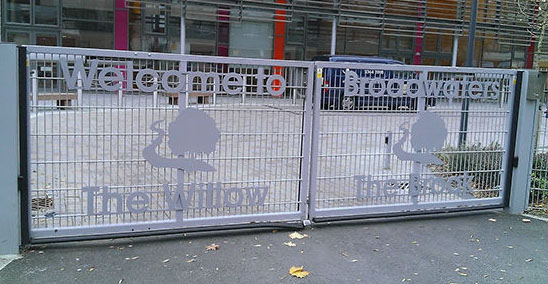 Laser cut lettering, powder coated gray and mounted to gates for Broadwater Farm.